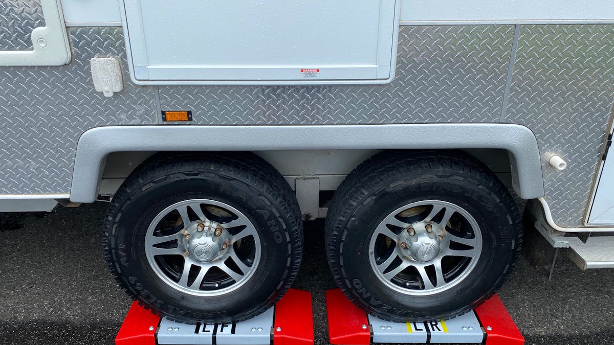 Dual axle caravan  wheels on red drive on scales