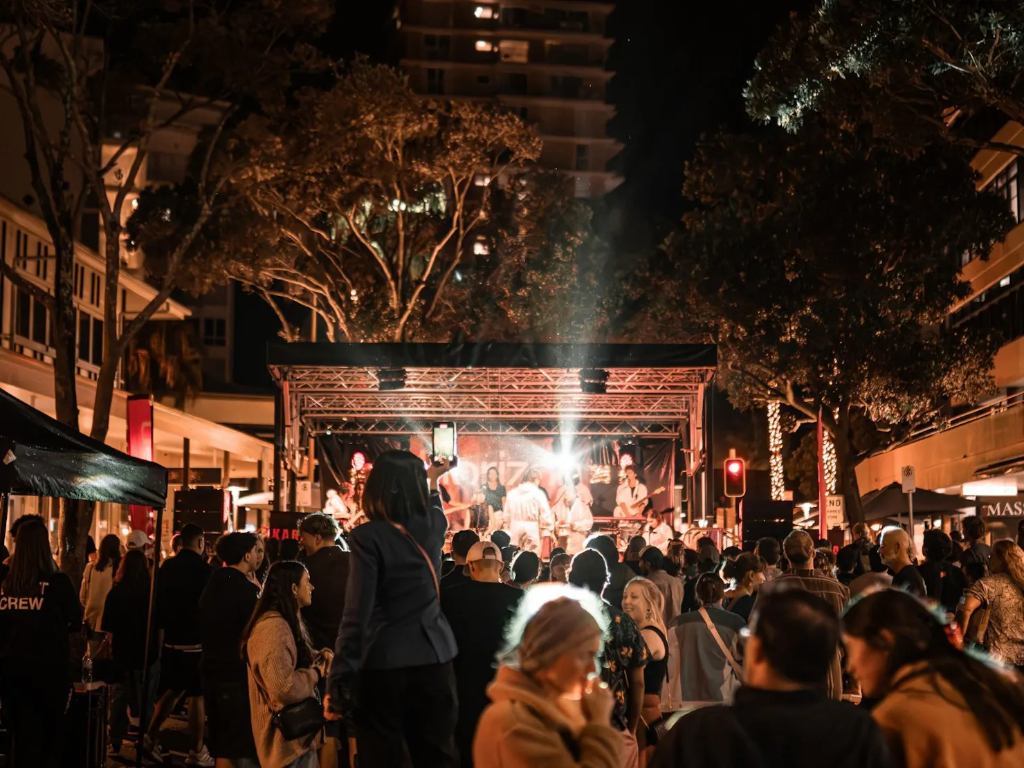 Night stage performance at Horizon Festival opening, crowd watching illuminated live show