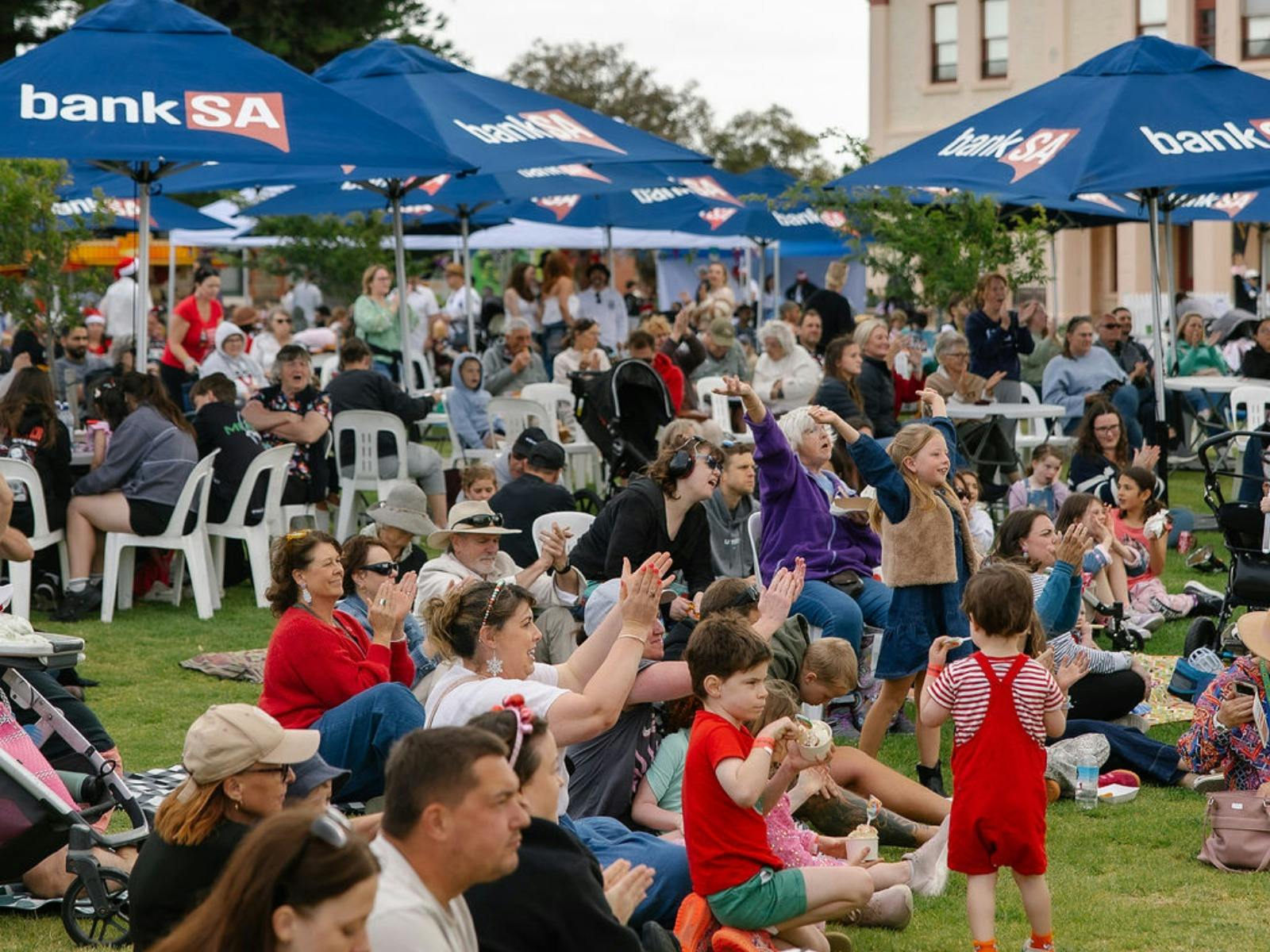 Visitors on the Minda lawns watching the performances