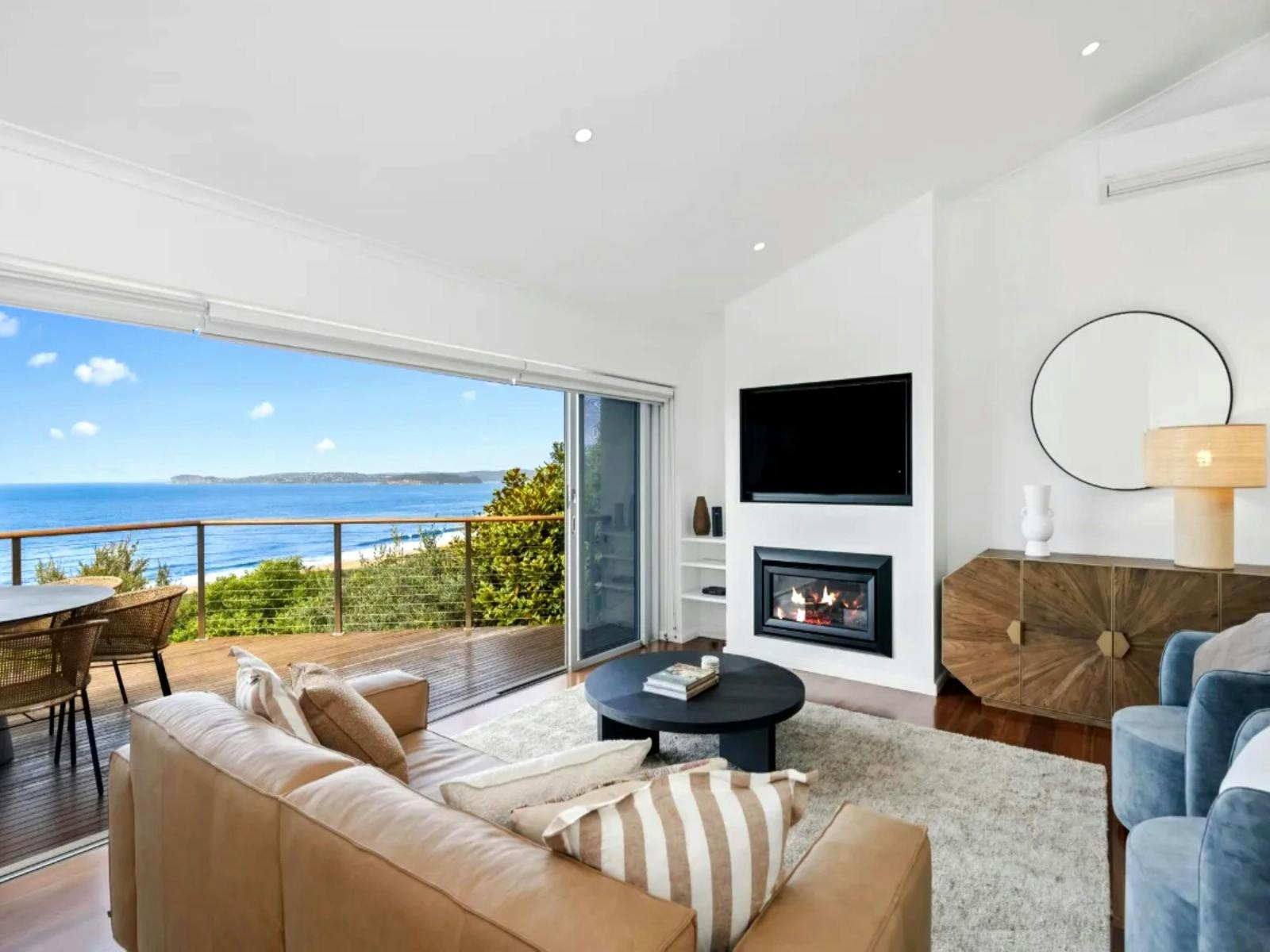 A cozy living room featuring comfortable seating and stunning vistas of the ocean