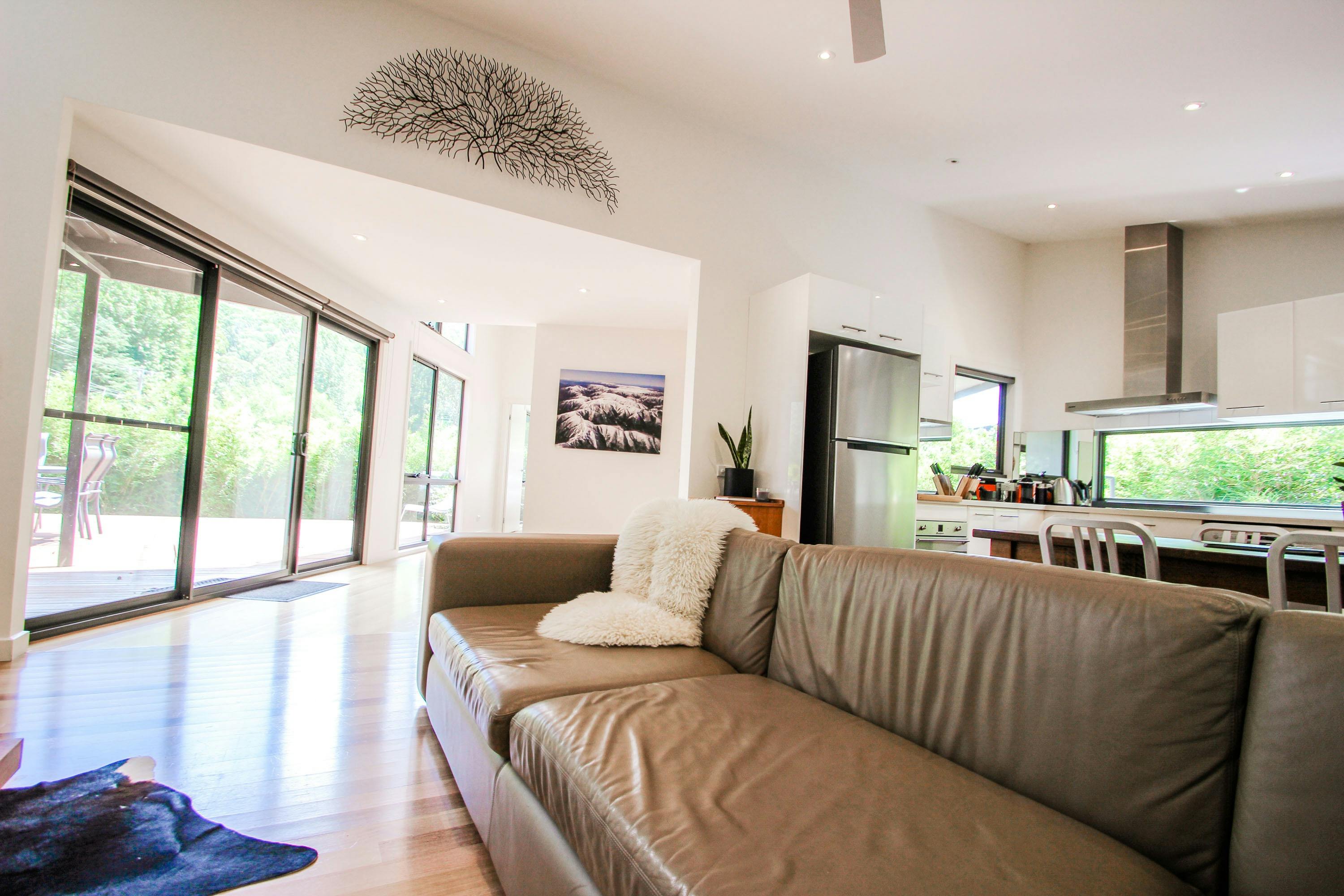 Light filled living, dining and kitchen area, corridor to bedroom