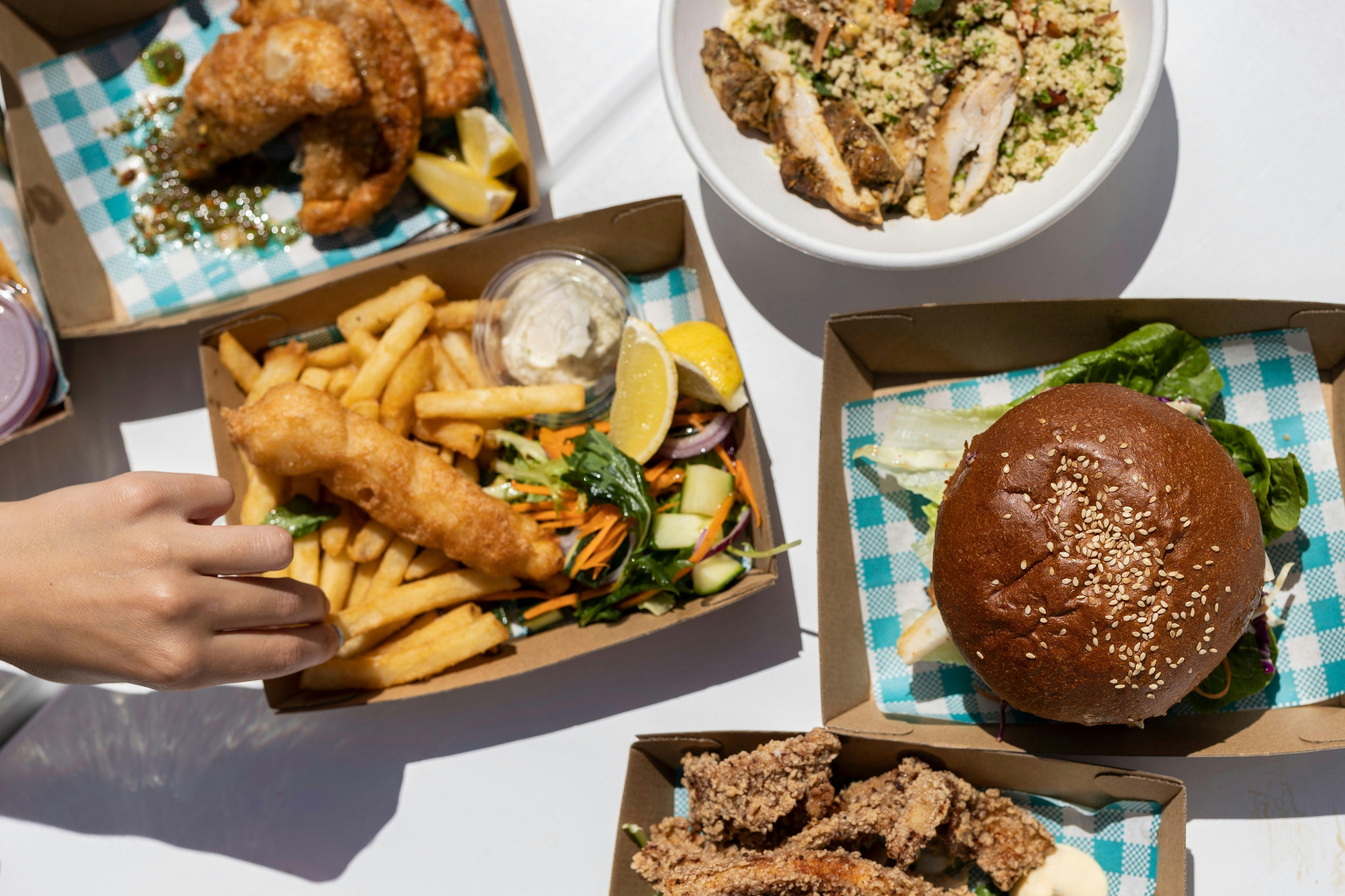 Fish and chips and burgers in a picnic setting