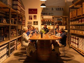 guests sit around table at private tasting experience in coonawarra