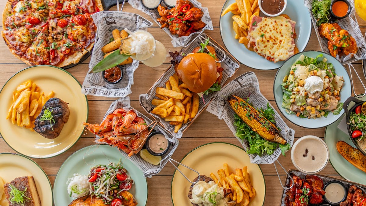 pub-style dishes at The Pub, Airlie Beach Hotel, featuring burgers, pizzas, and share plates