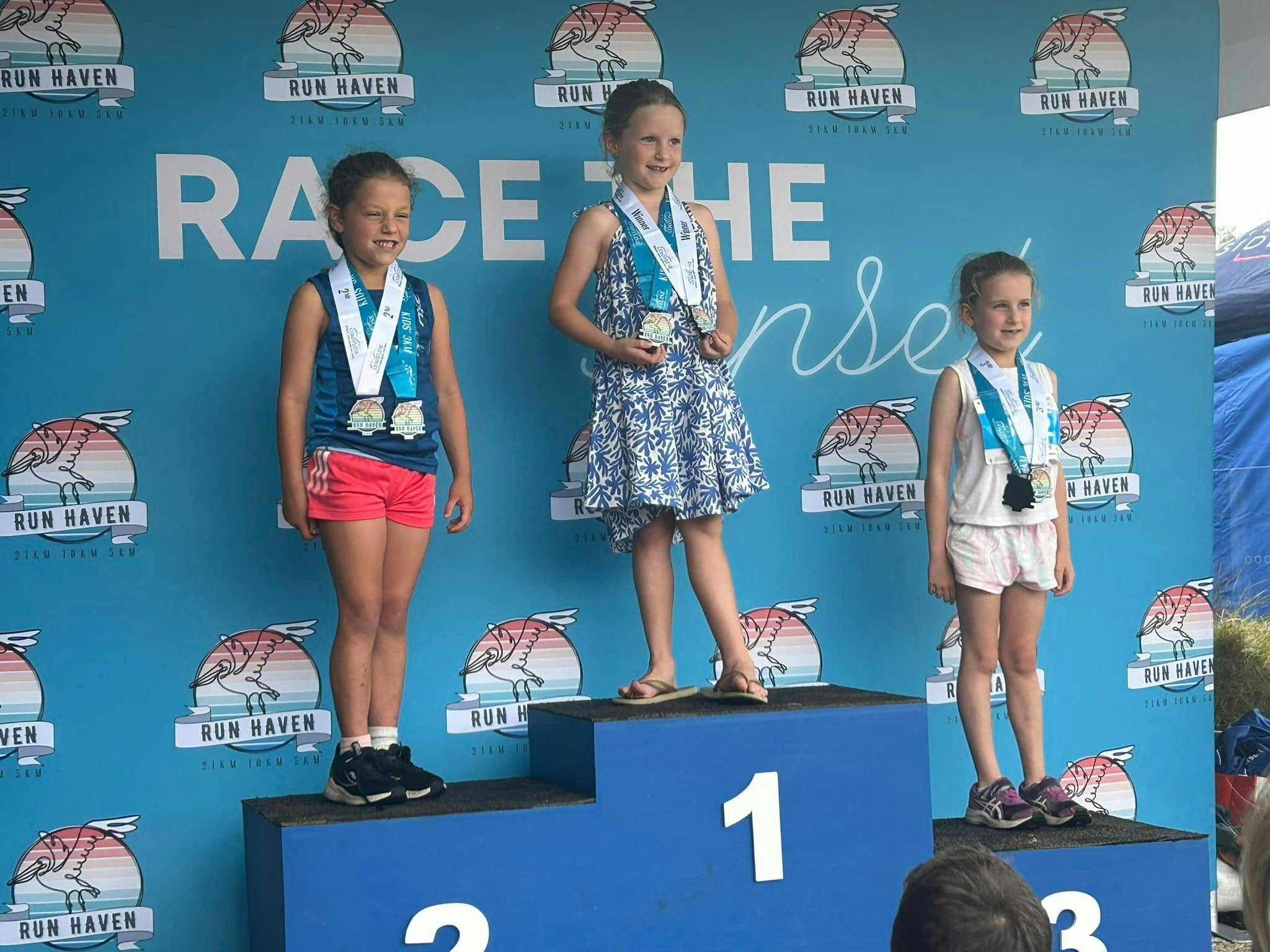 Three children with their medals.