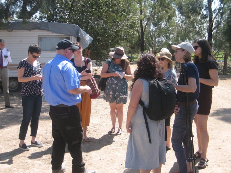 Organic rice farmer discusses his farming operation with Sydney visitors.