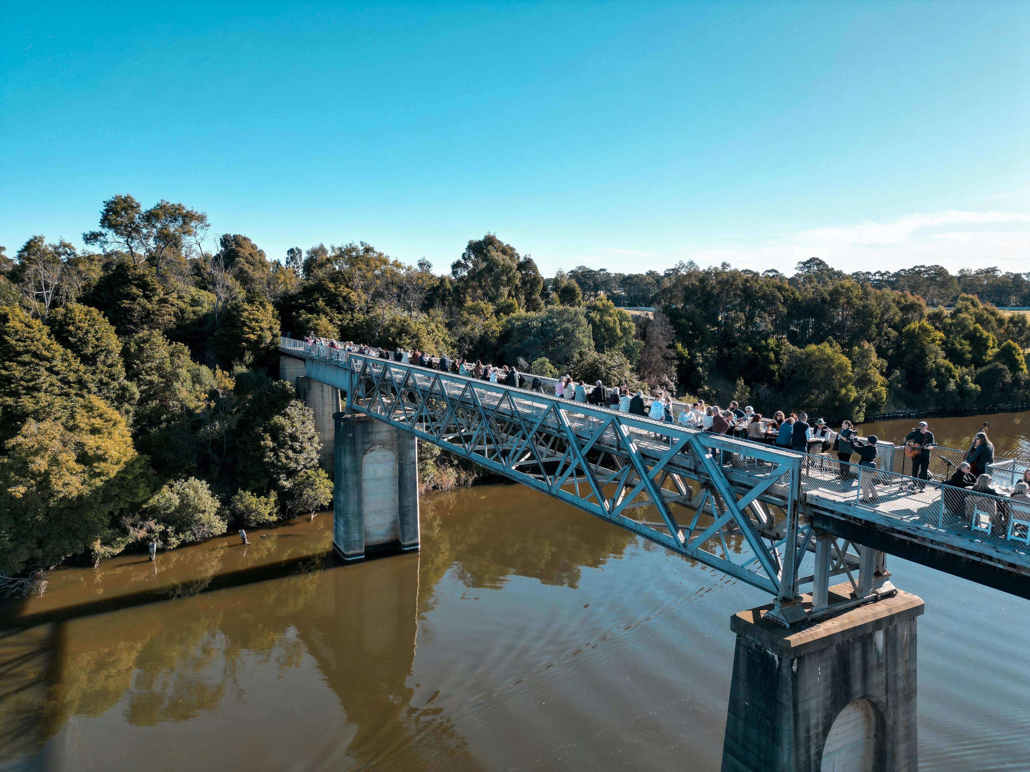 Long lunch on the Nicholson River Railway Bridge, high above the Nicholson River with blue skies