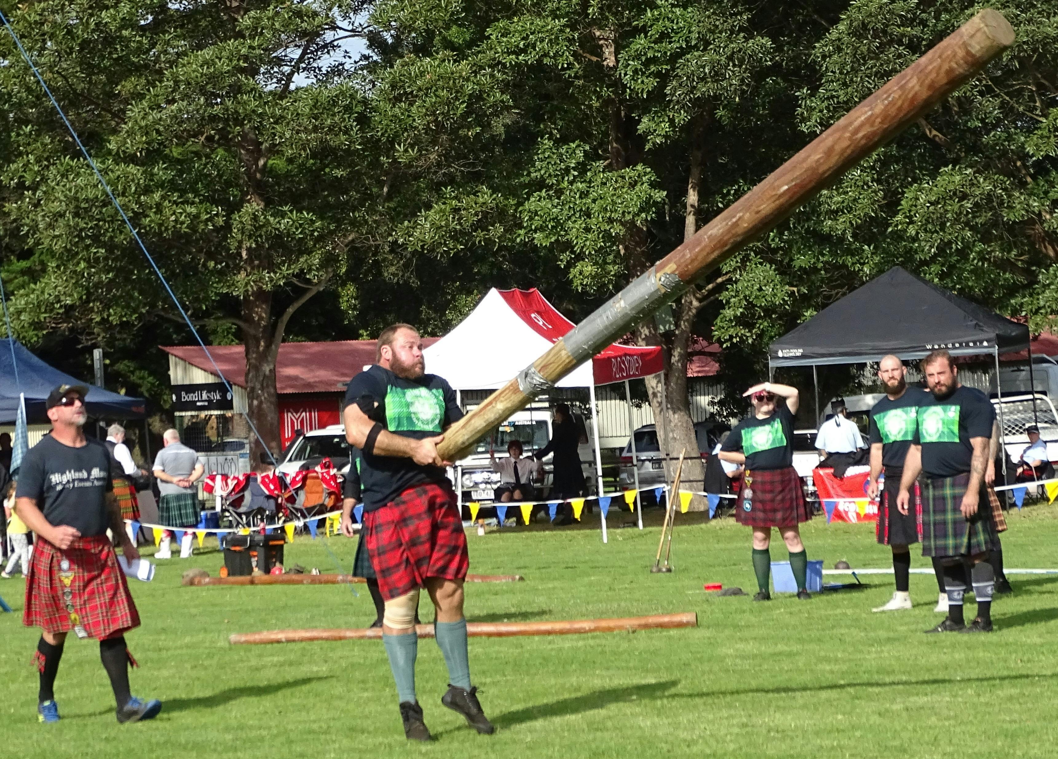 Highland strongmen compete in the caber tossing