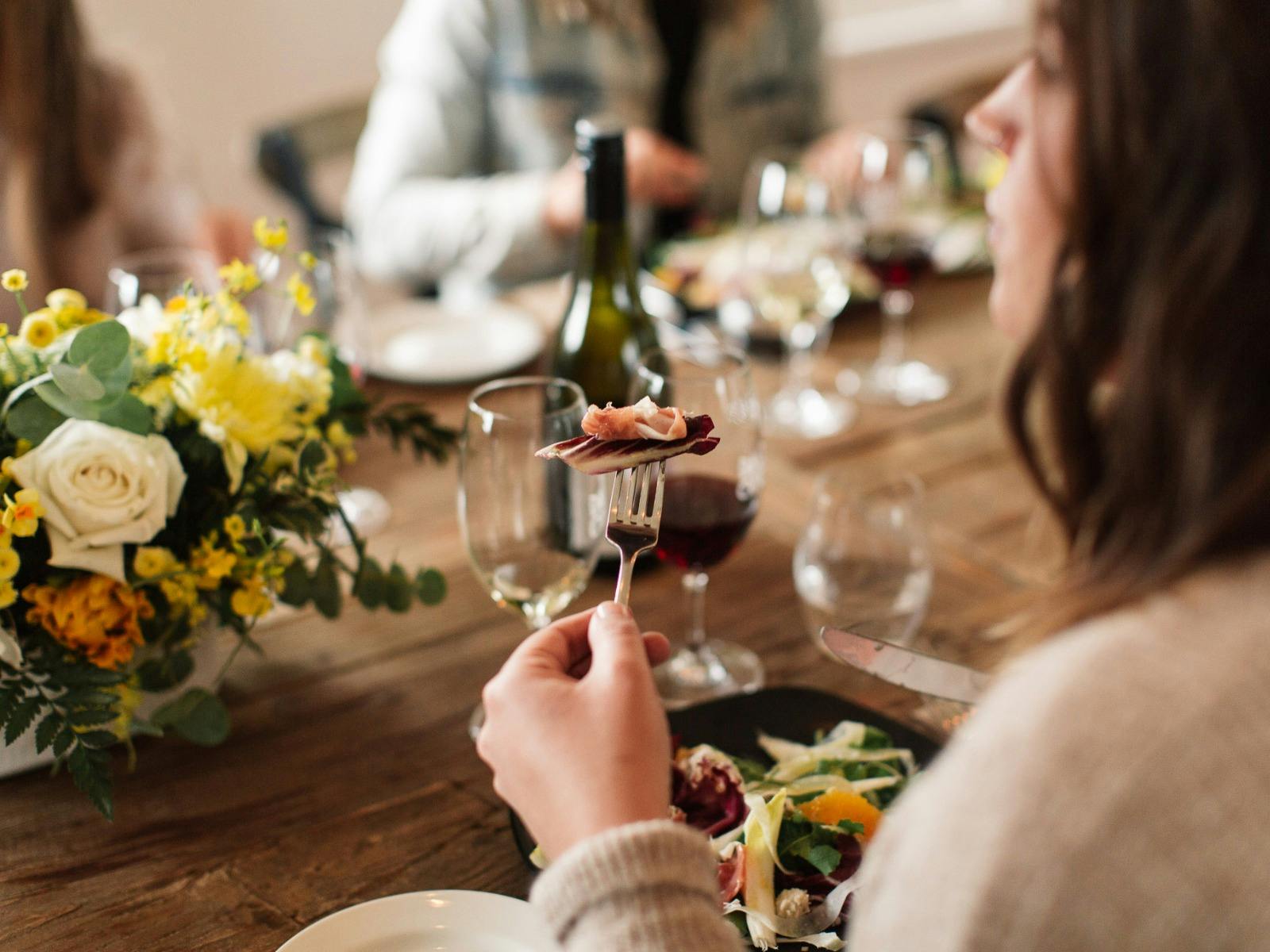 Dal Zotto Wines a woman enjoying lunch and a glass of wine in the trattoria