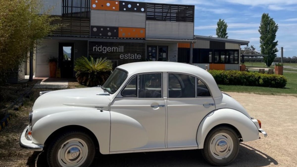 Vintage car parked outside cellar door