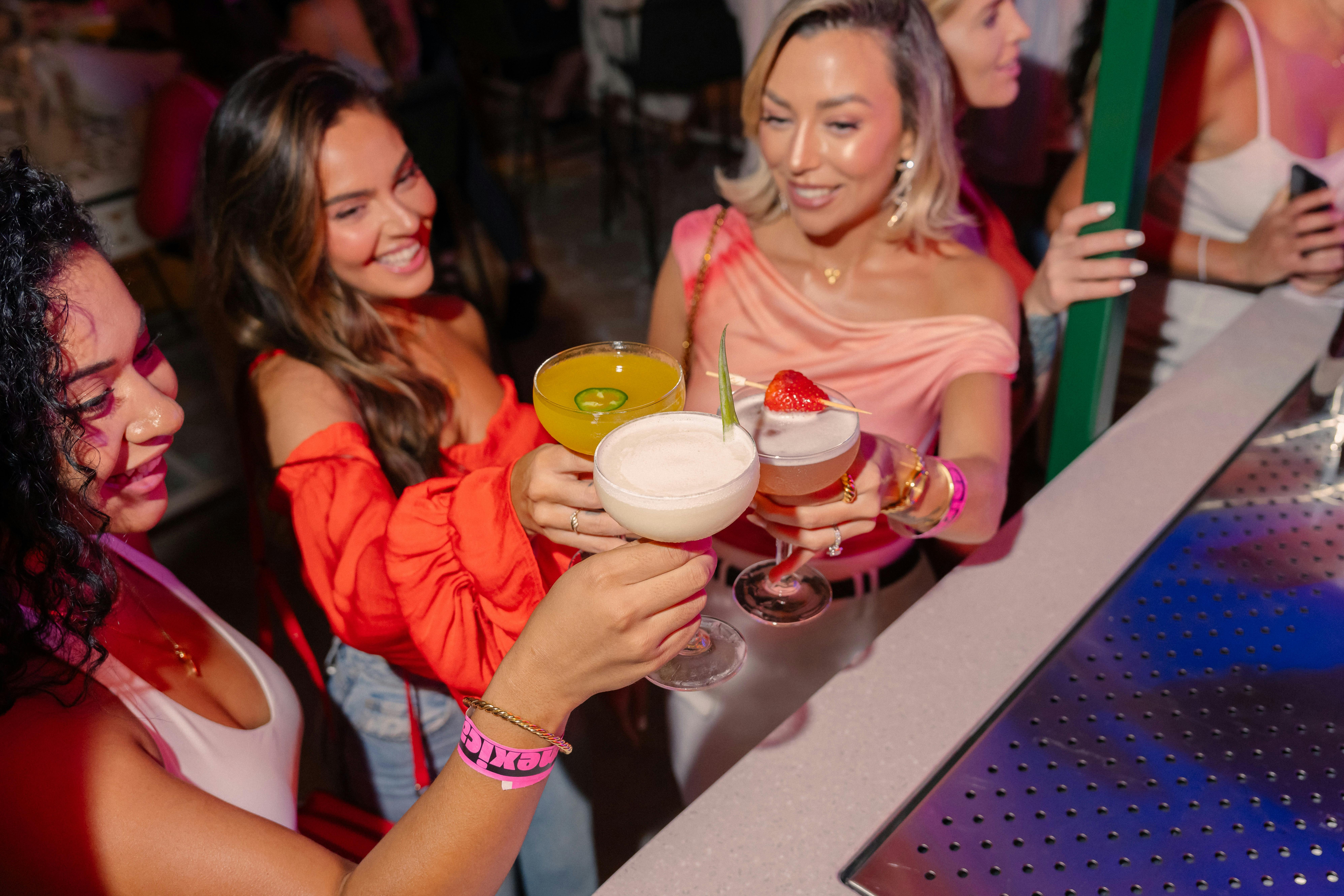 3 girls holding cocktail