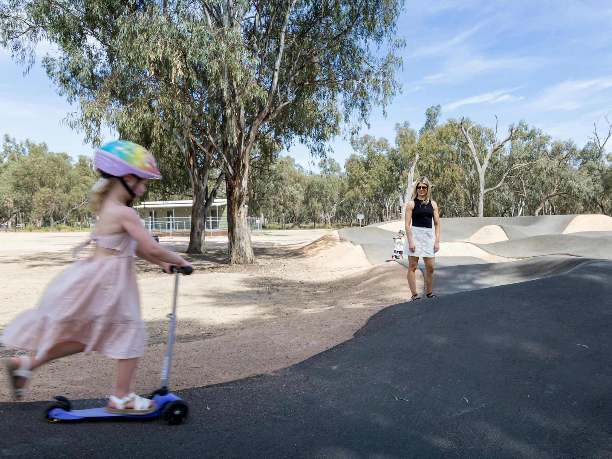 Girl  riding scooter at park