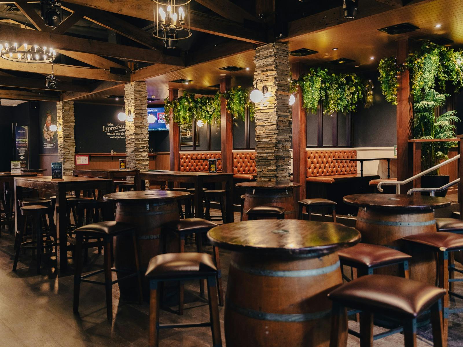 Inside bar with wooden tables and chairs in a room