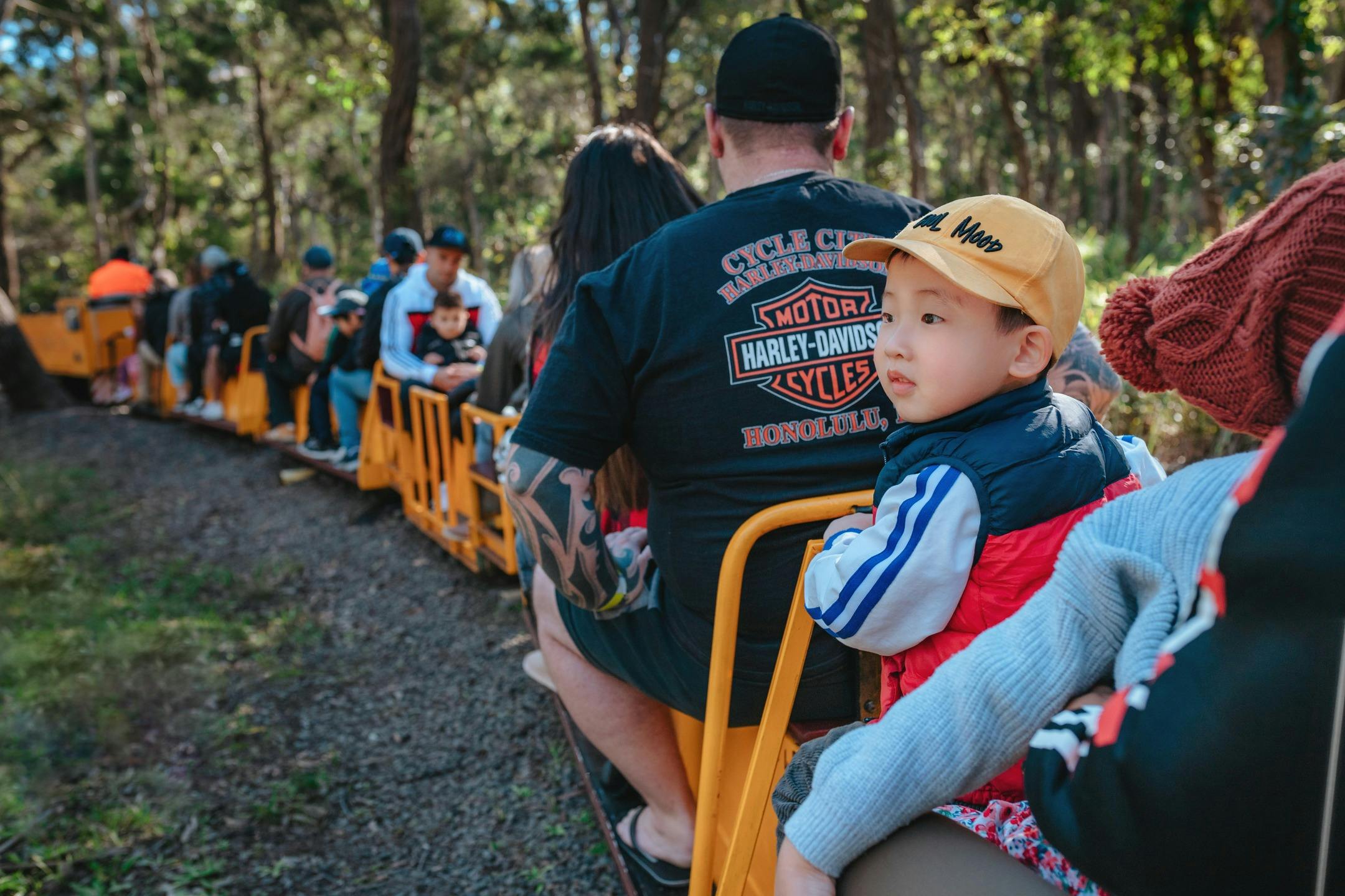 Family riding the miniture train at the Illawarra Lightrail Museum