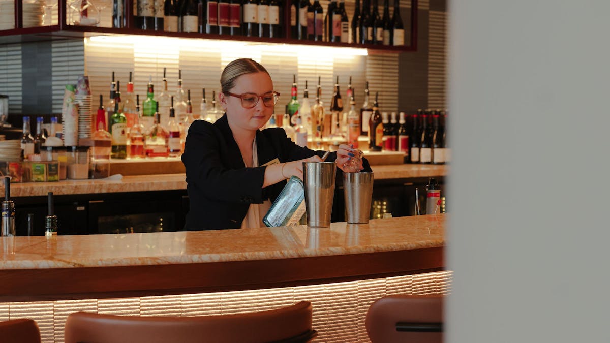 A bartender making a cocktail at Cucina Regina
