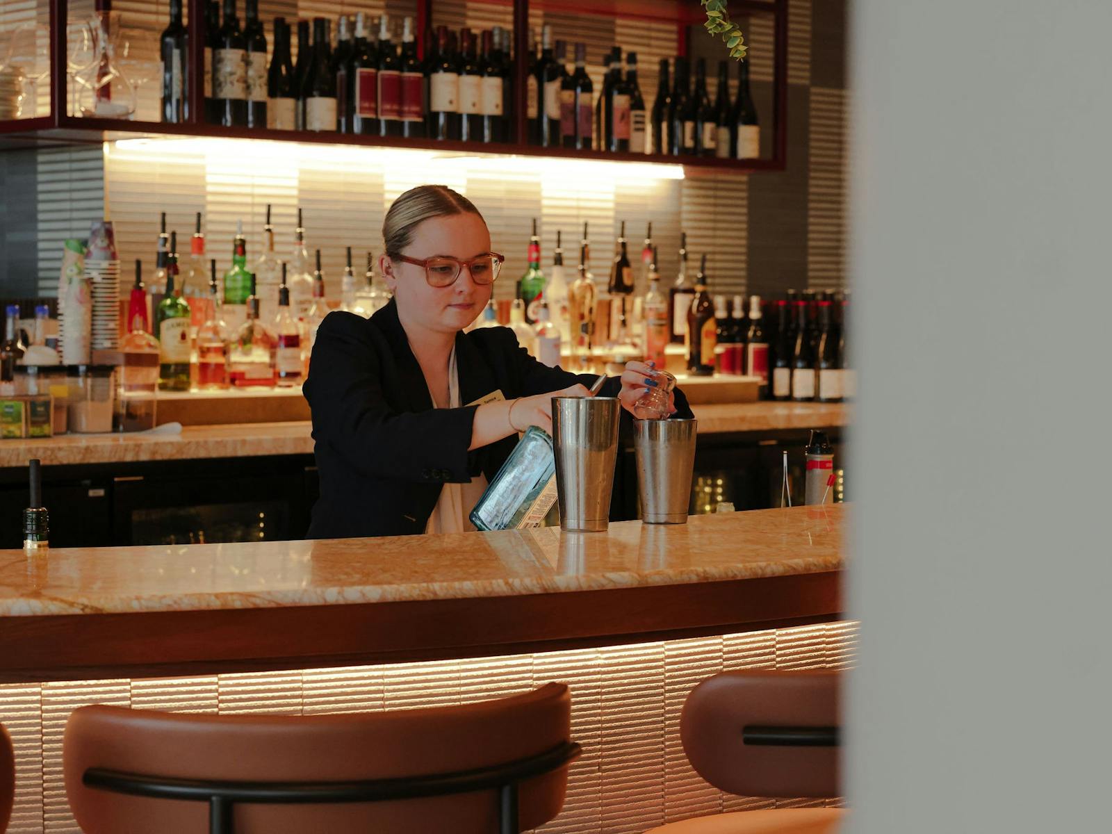 A bartender making a cocktail at Cucina Regina A bartender making a cocktail at Cucina Regina