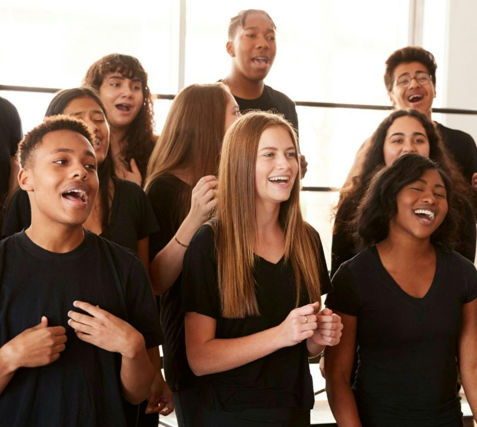 Young people happily singing and wearing black tshirts