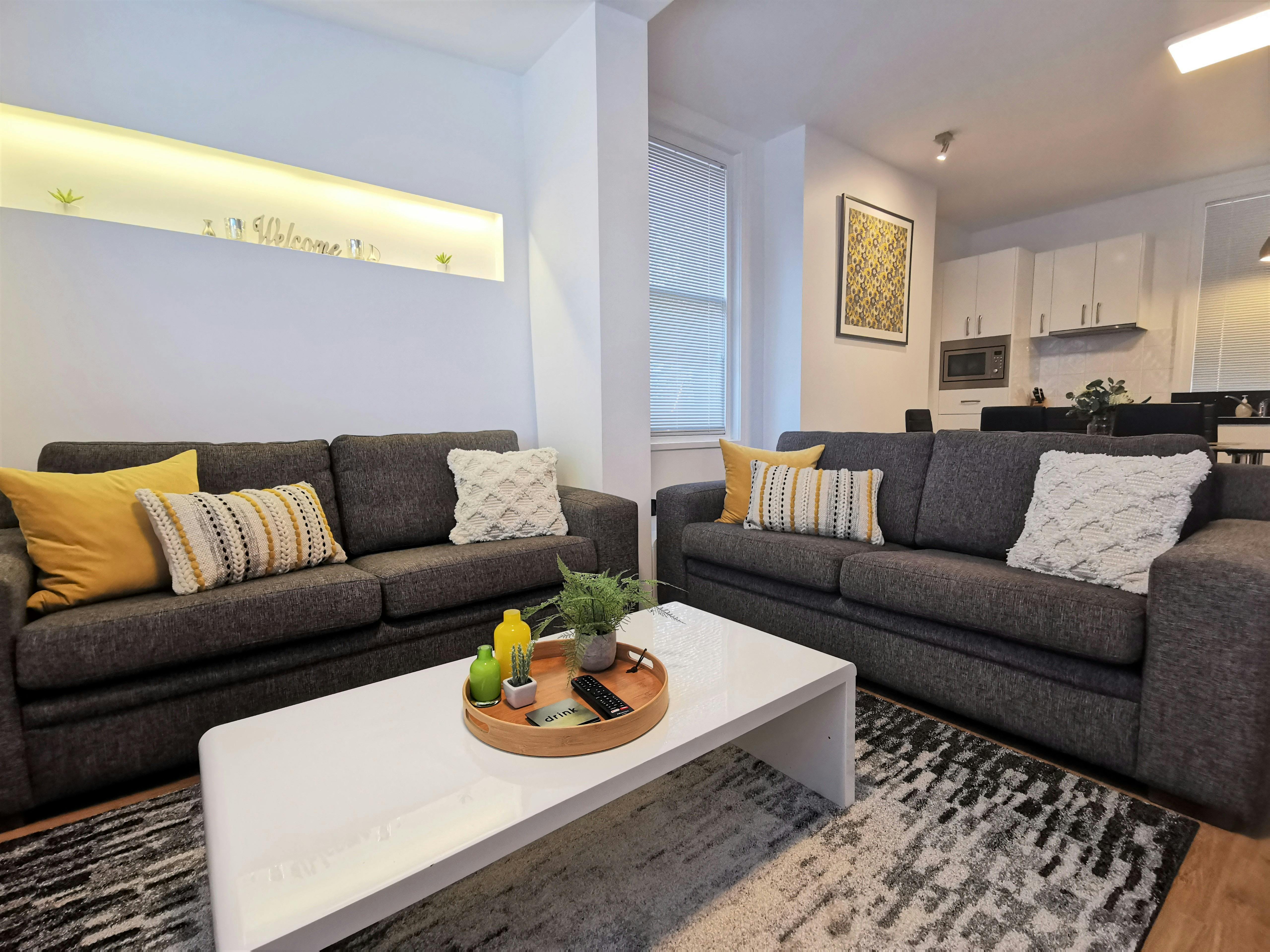 Open-plan living room with comfortable lounge, dining area and natural light.