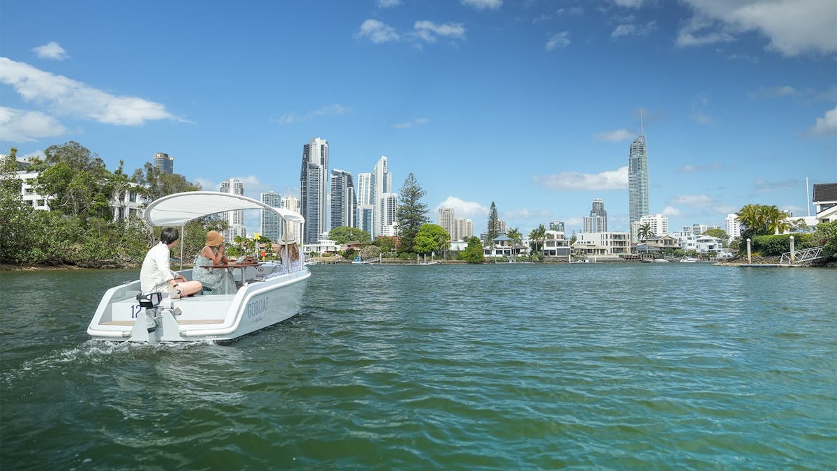 A GoBoat sails on the Nerang River, looking towards Surfers Paradise.