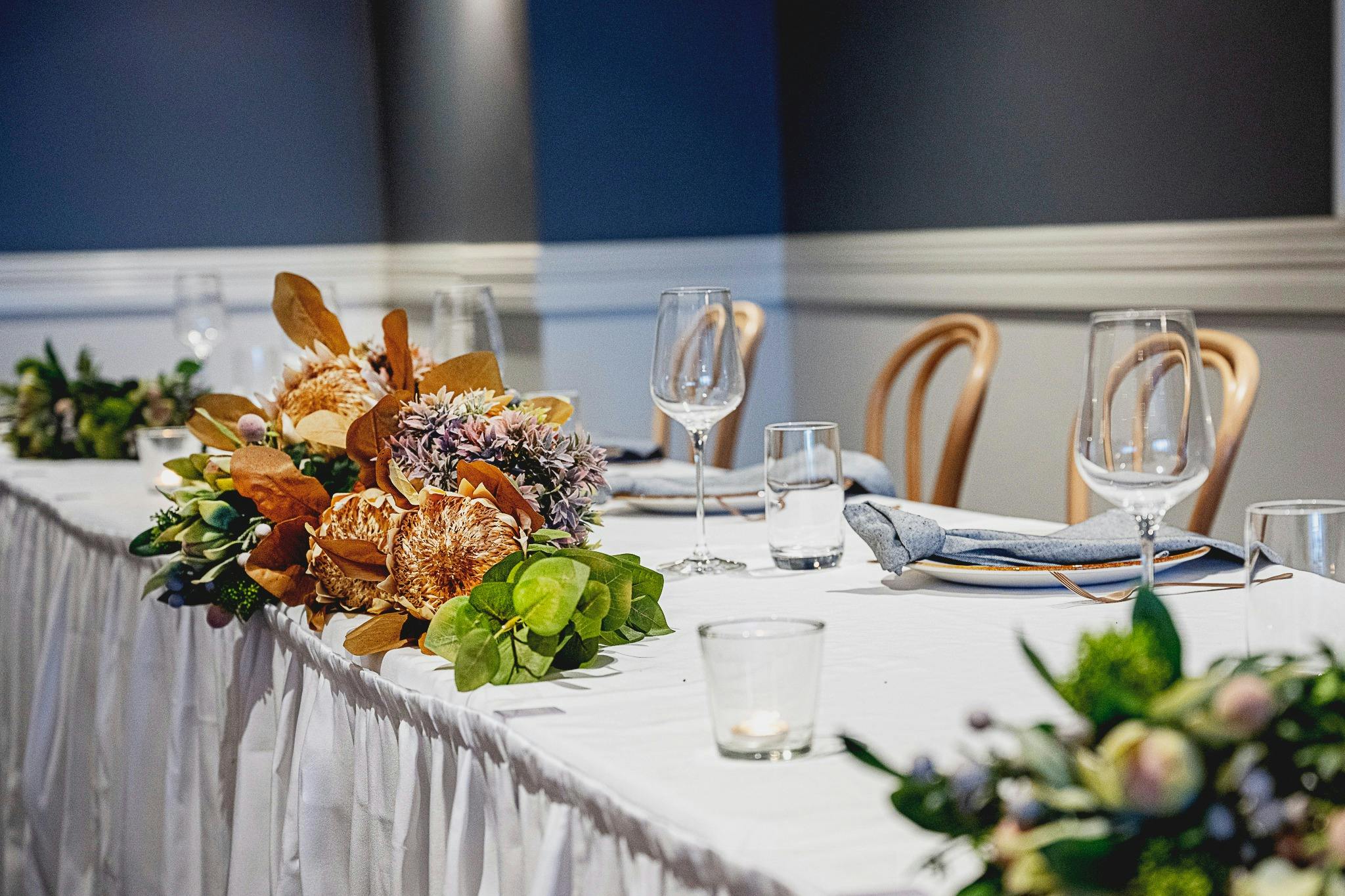 wedding rtable setting white cloth and native flowers
