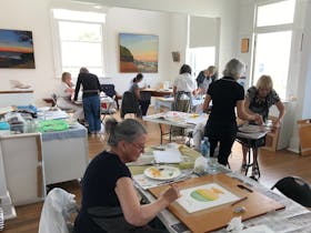 A group of people participate in an art workshop.