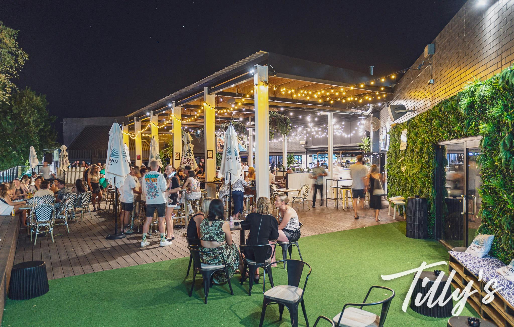 Ourdoor Area of Tilly's with festoon lighting and people enjoying food and drink