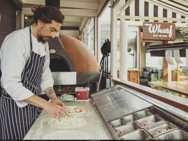 making pizza at the wharf bar and restaurant