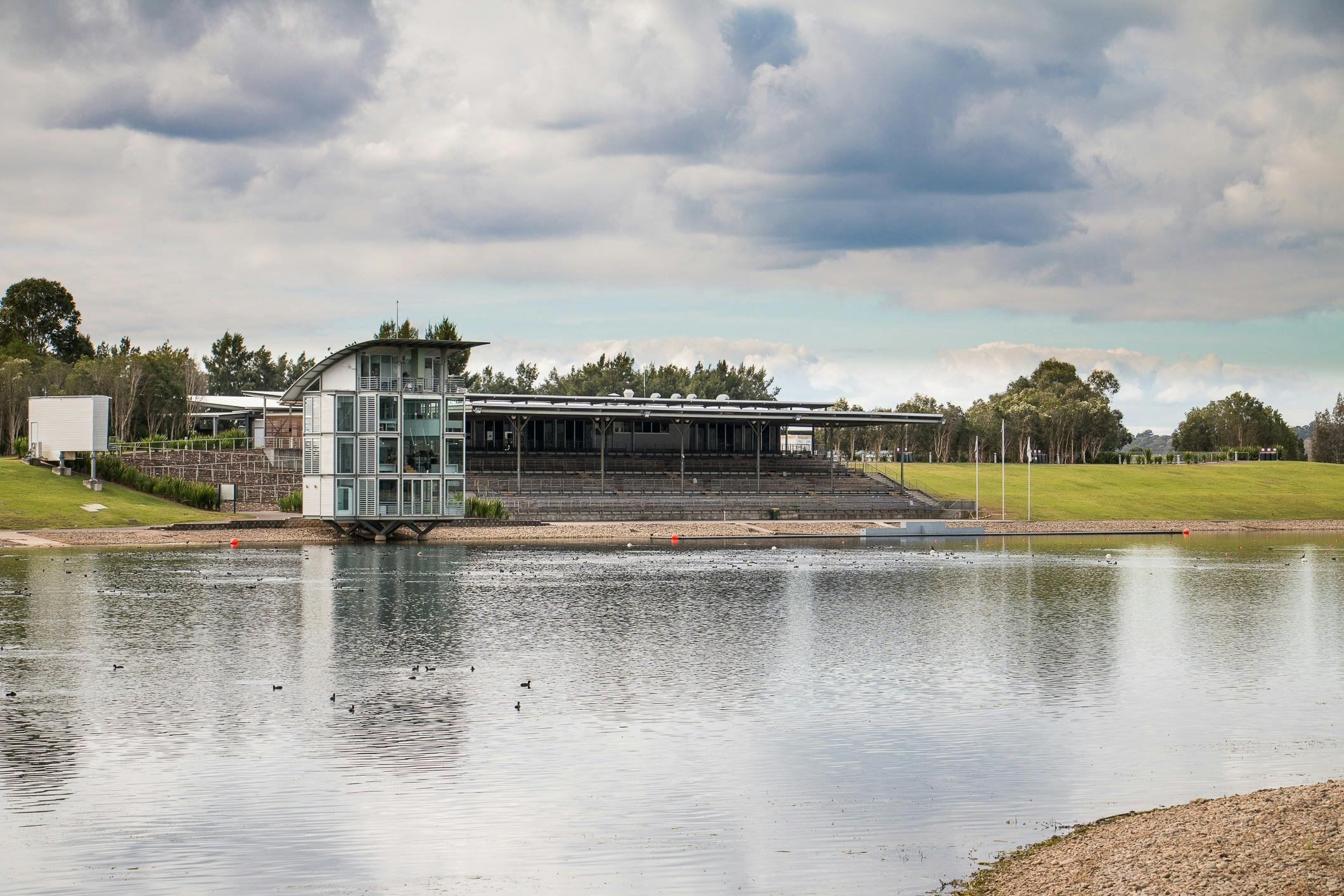 Picturesque photo of rowing lake with main stand in the background.