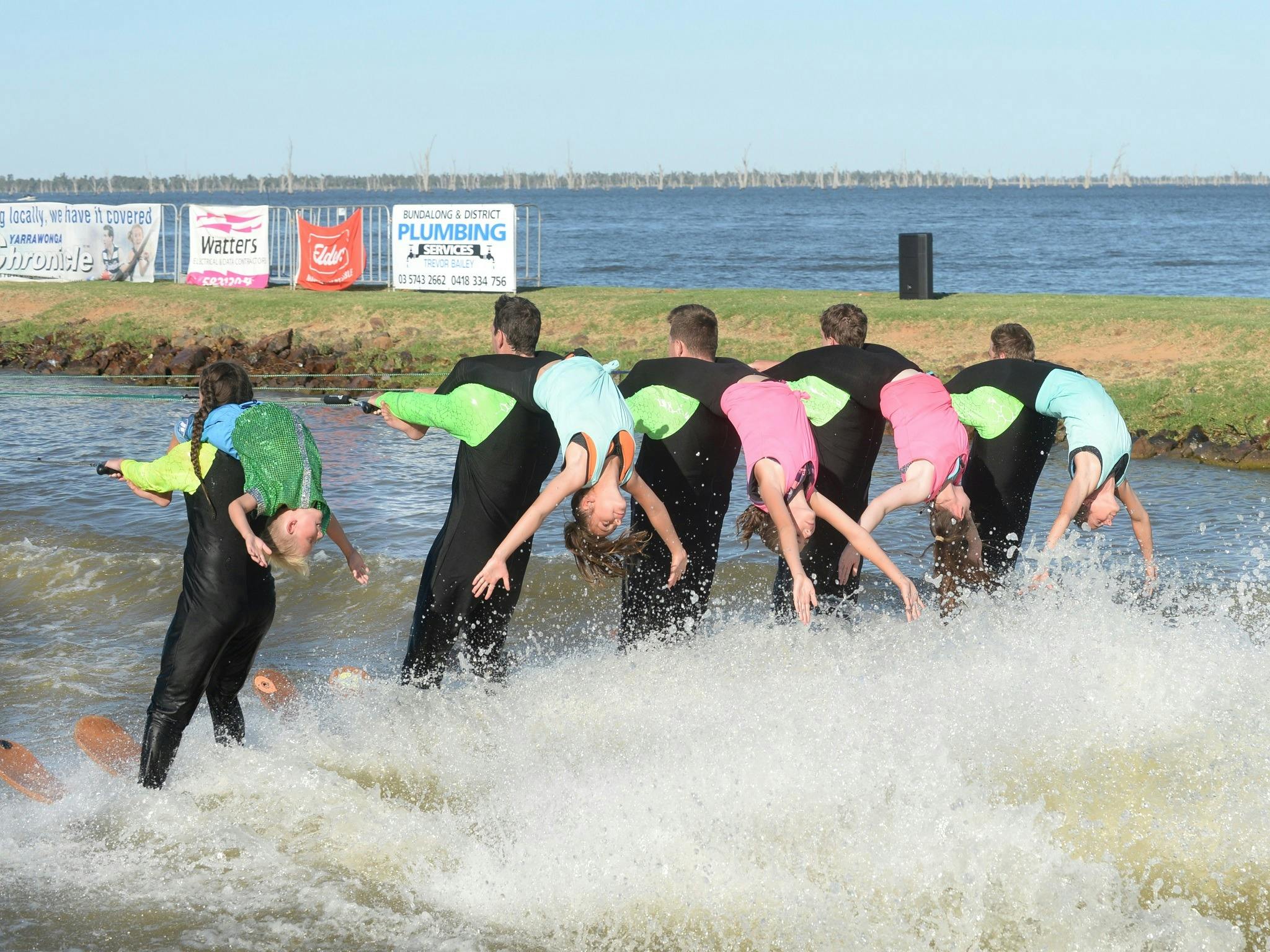 Water Skiing action on the grassed foreshore.