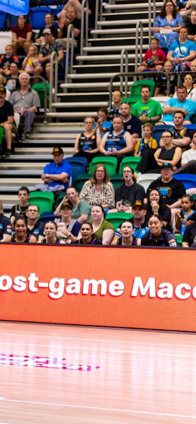 UC Capitals player driving to the basket for a layup during a WNBL game.