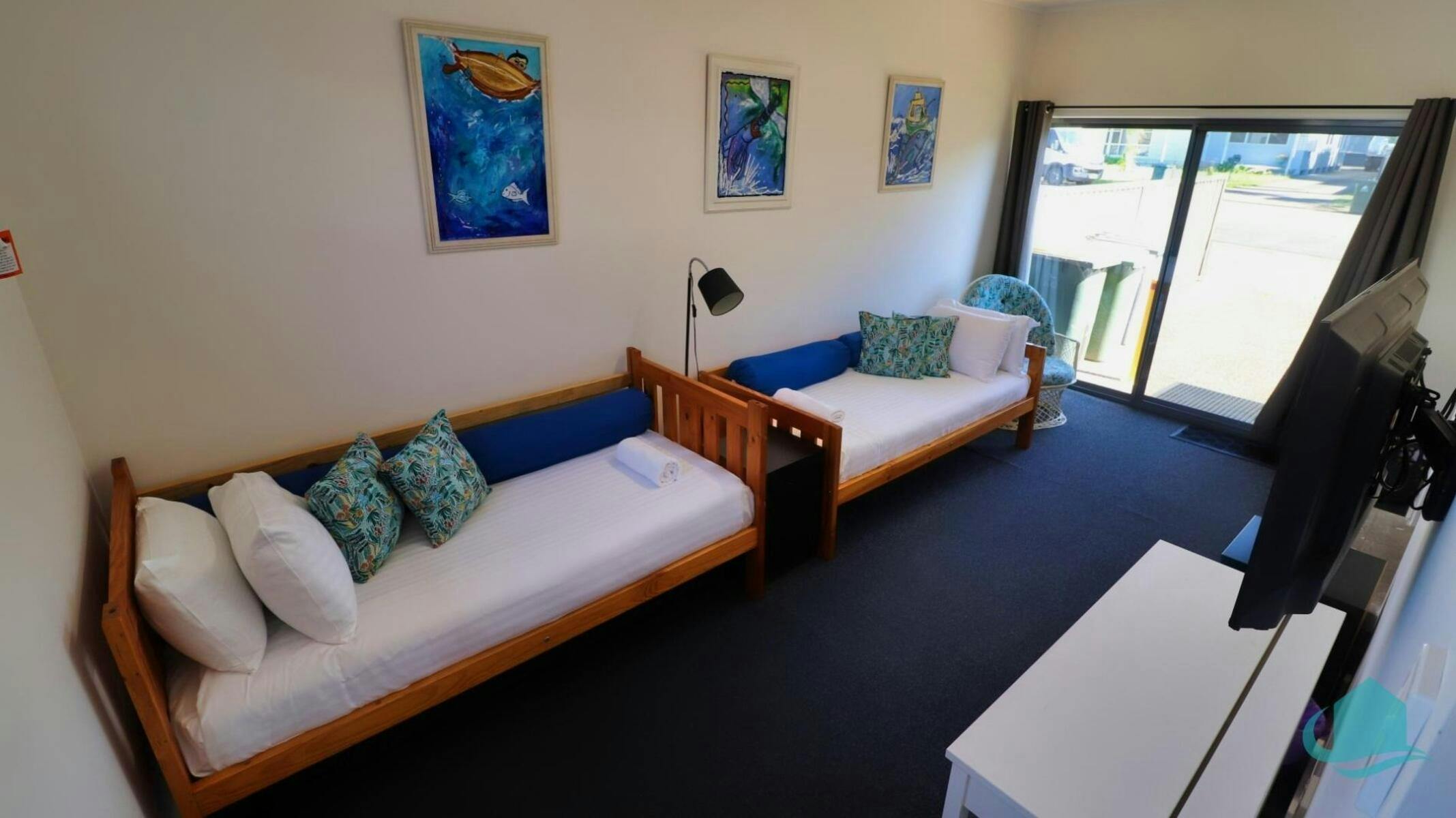 Third bedroom with two single beds and wall mounted TV