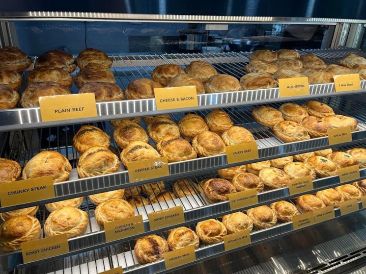 different flavour pies in a pie shelf