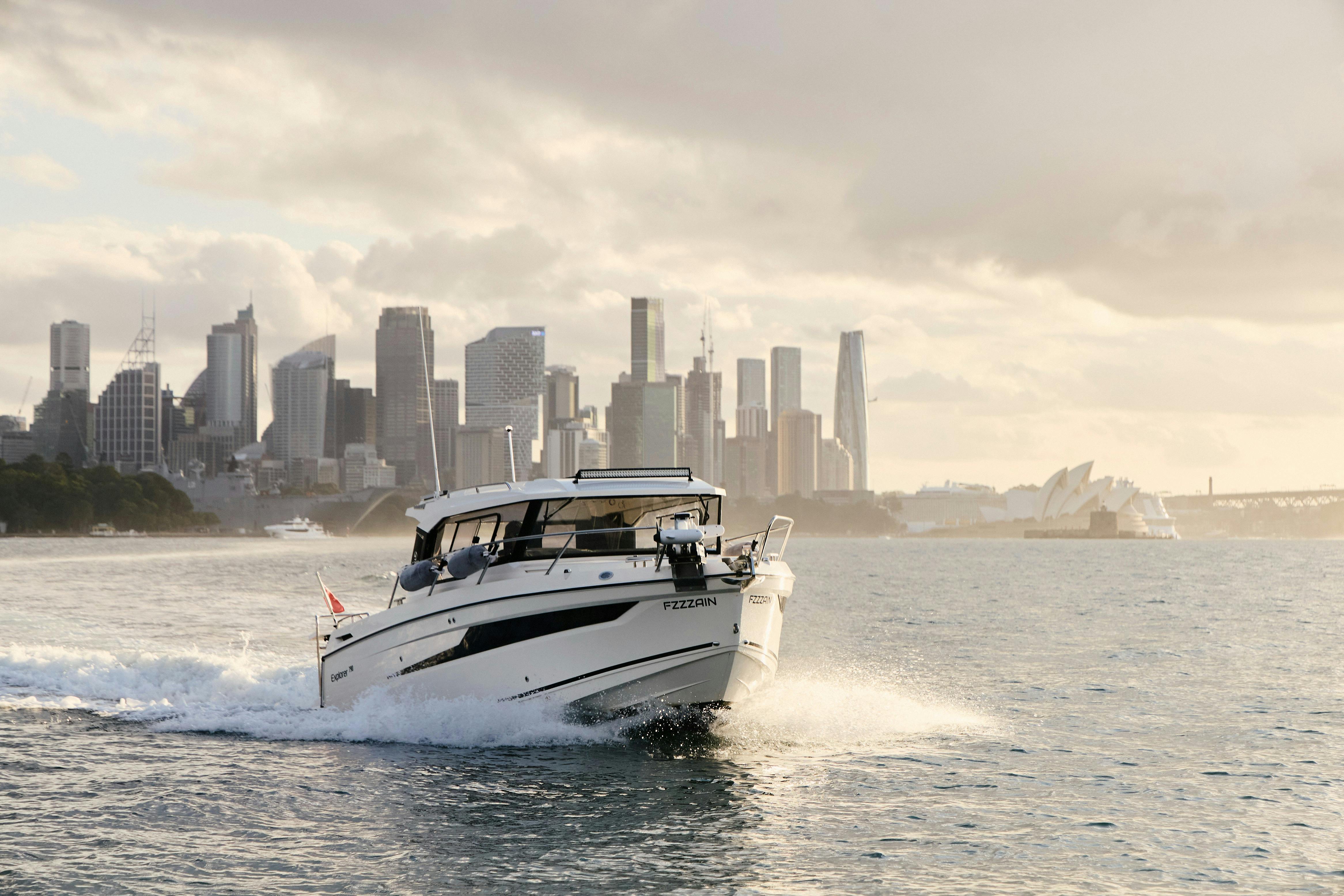 MV Explorer luxury cruise boat on Sydney Harbour with Harbour Bridge in the background.