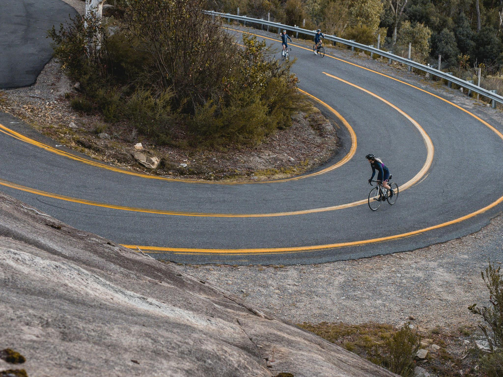 Road cyclists riding up the winding road of Mount Buffalo