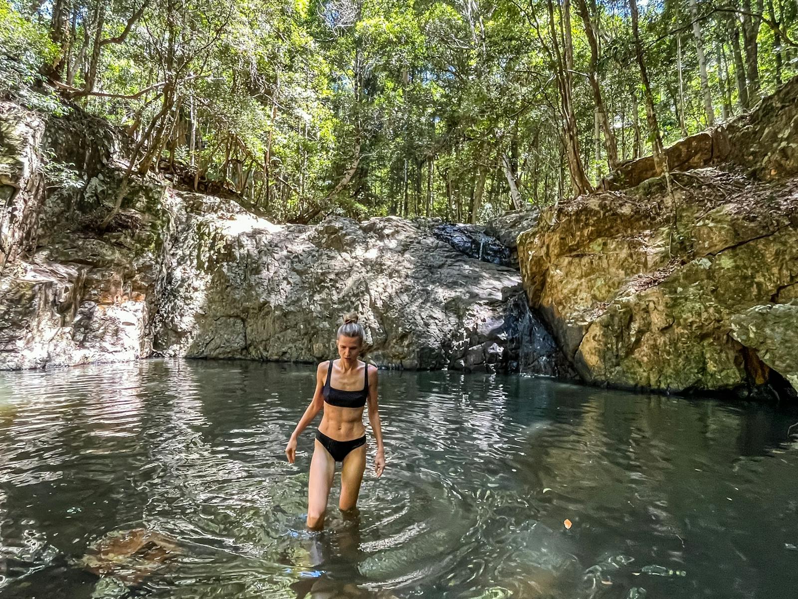 Woman coming out of the pool at Unicorn falls in Mount Jerusalem National Park