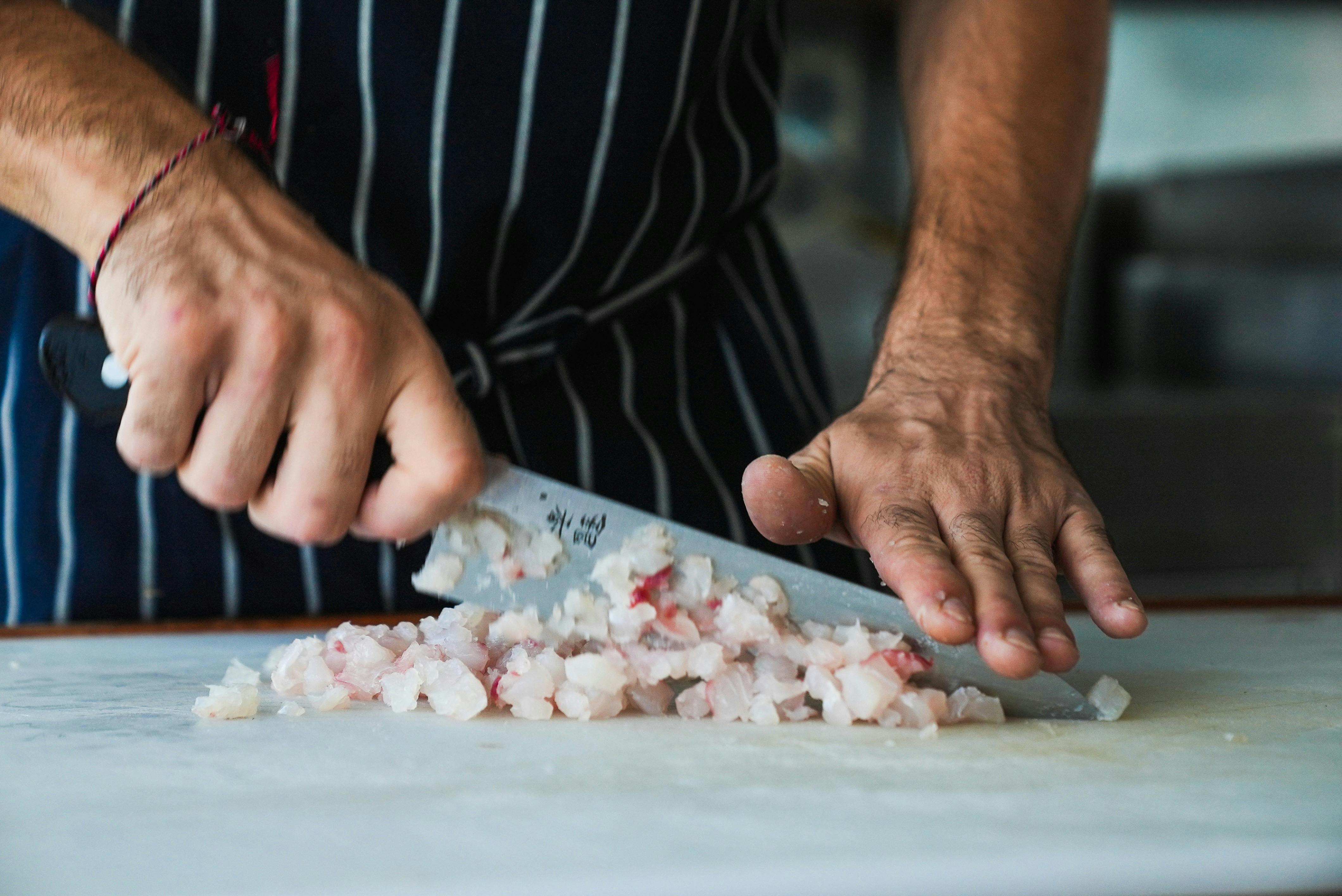 Freshly caught fish being cleaned and prepared on board, ready for cooking and serving.