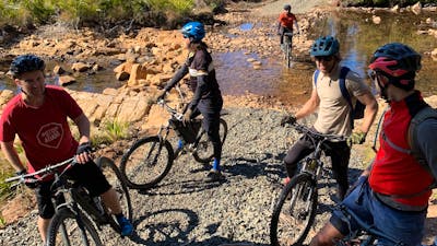 Cyclists next to river