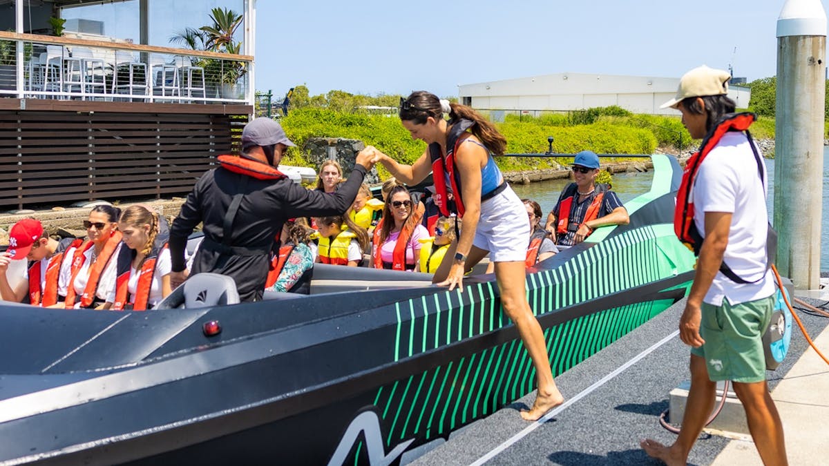 Jet Boat Driver assisting a guest to get into the Arro Jet Boat.