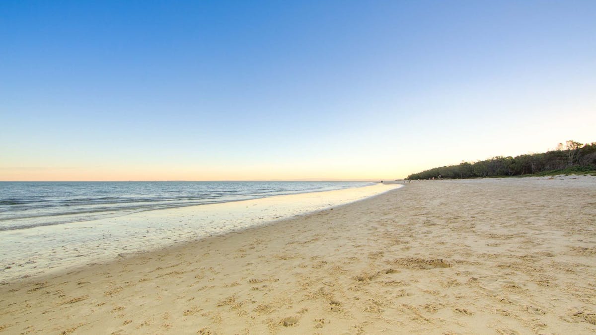 Beach and ocean water at sunset