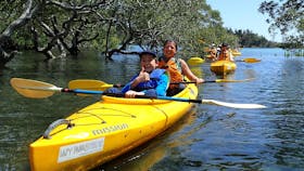 Mother and son enjoying a guided kayak tour