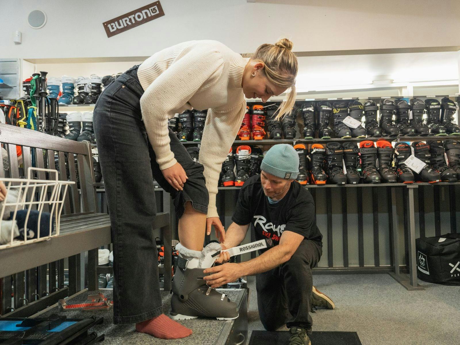 Person getting boots fitted at Ray's Ski Hire