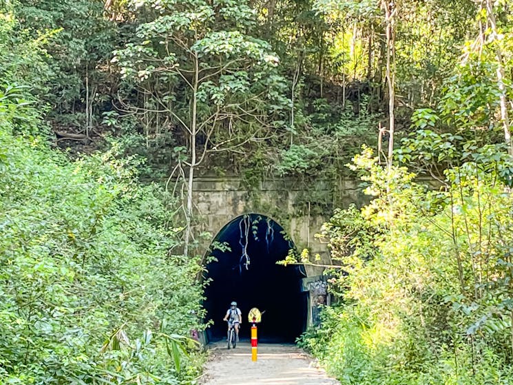 Shot of 500m long Burringbar tunnel exit  showing e bike rider coming towards camera.
