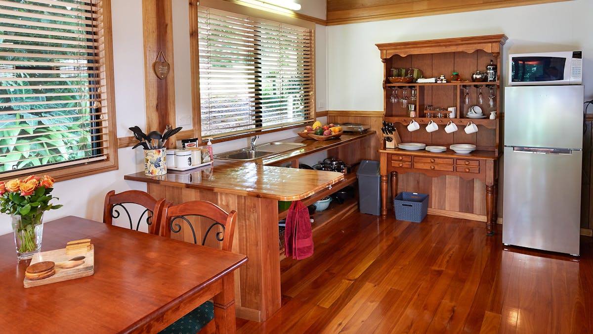 alt="Fully self-contained kitchen and dining area at Sharlynn by the River"