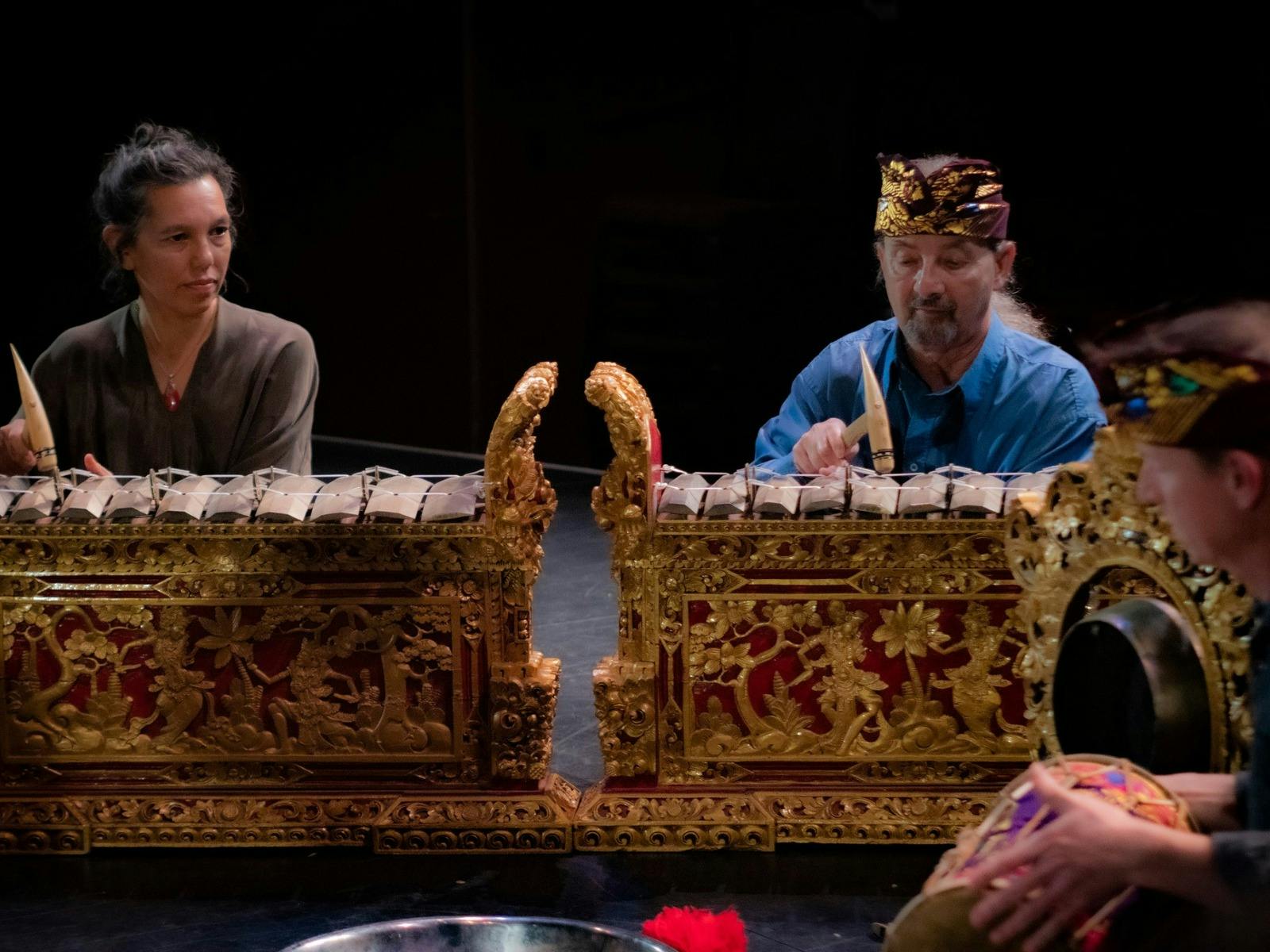 2 musicians sitting behind a Balinese gamelan.