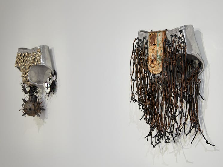 Two mixed media metal sculptures in the form of undies with adornment