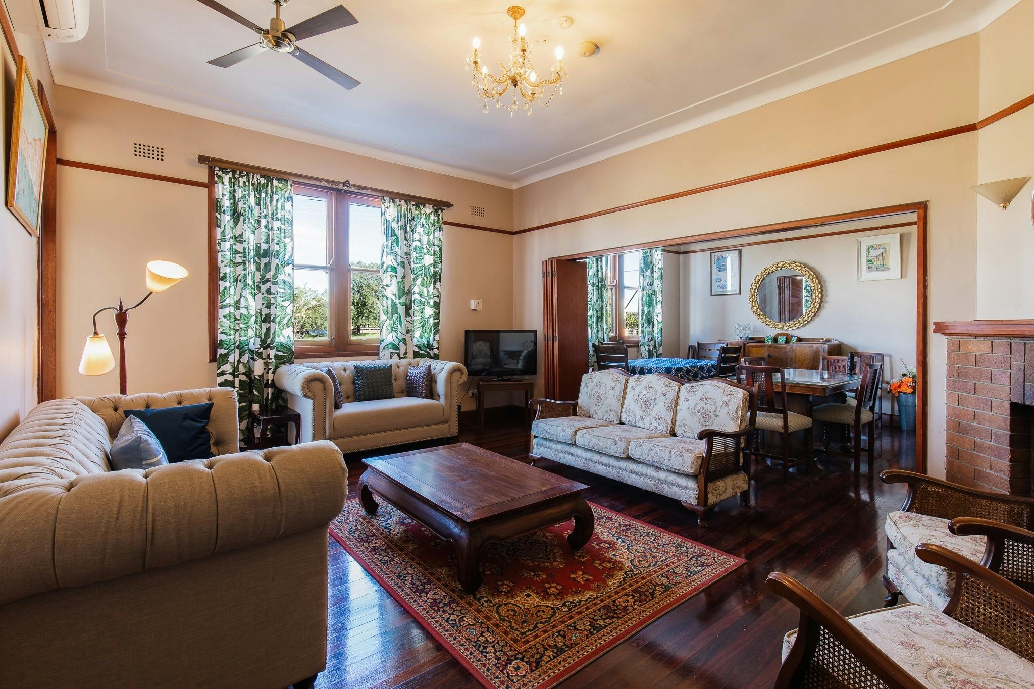 Polished timber floor comfortable lounges airconditioners tables chandelier