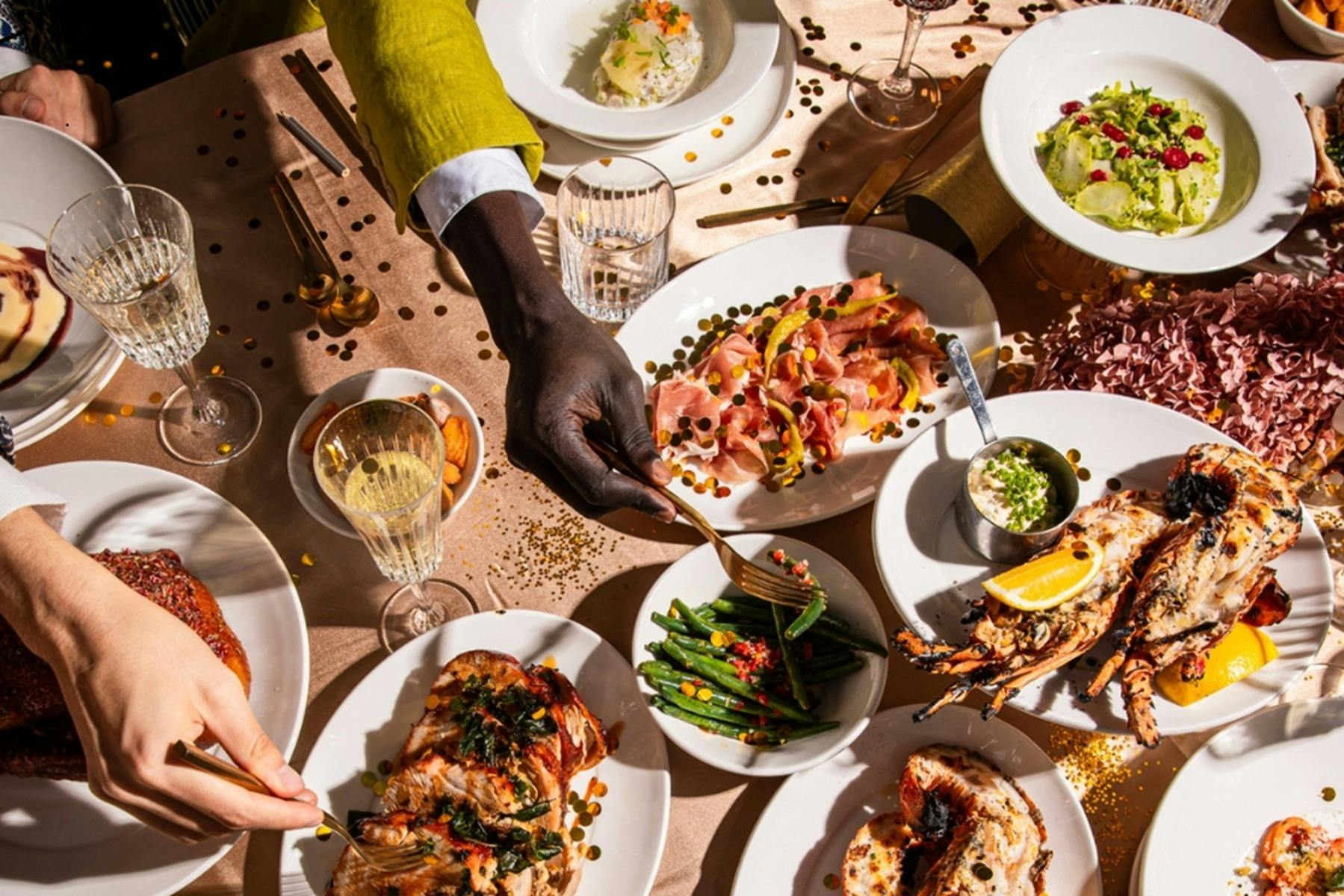 Platters of food spread out on beige table