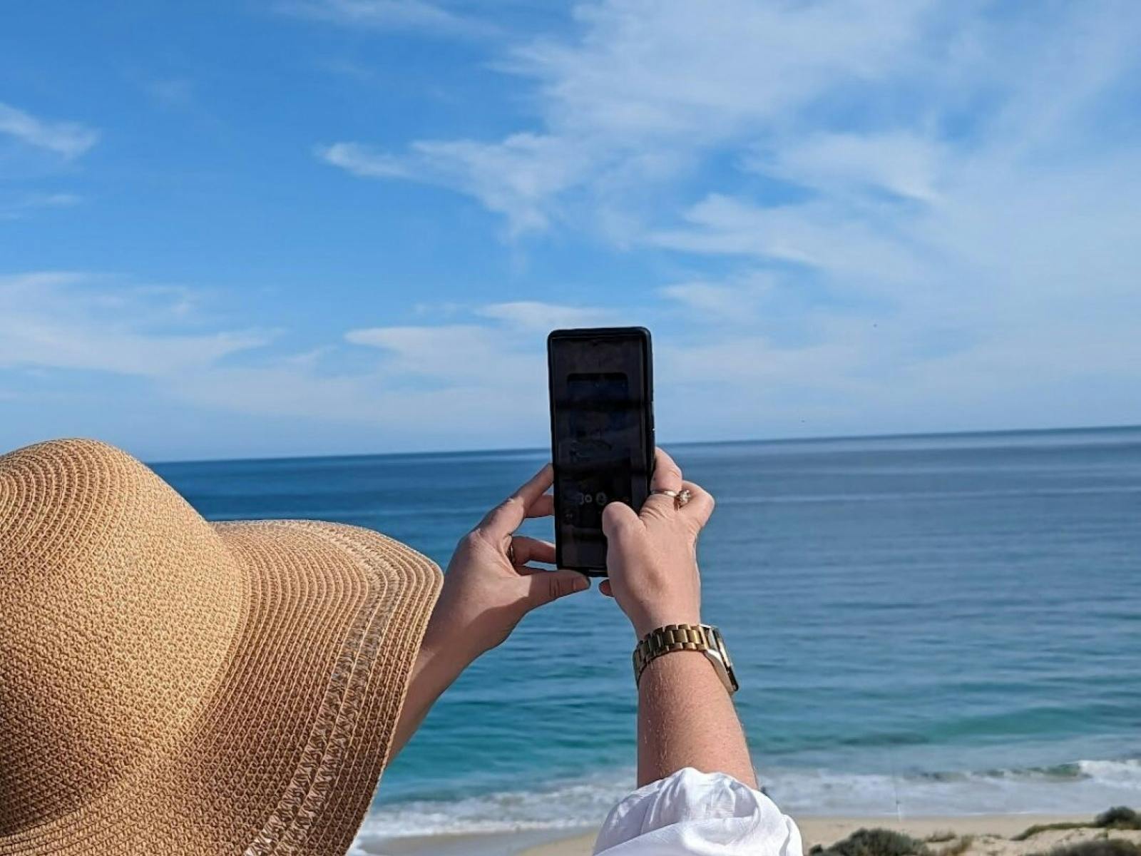 Woman using augmented reality on a mobile at Guilderton Beach
