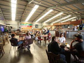 People sitting at tables in the cellar door