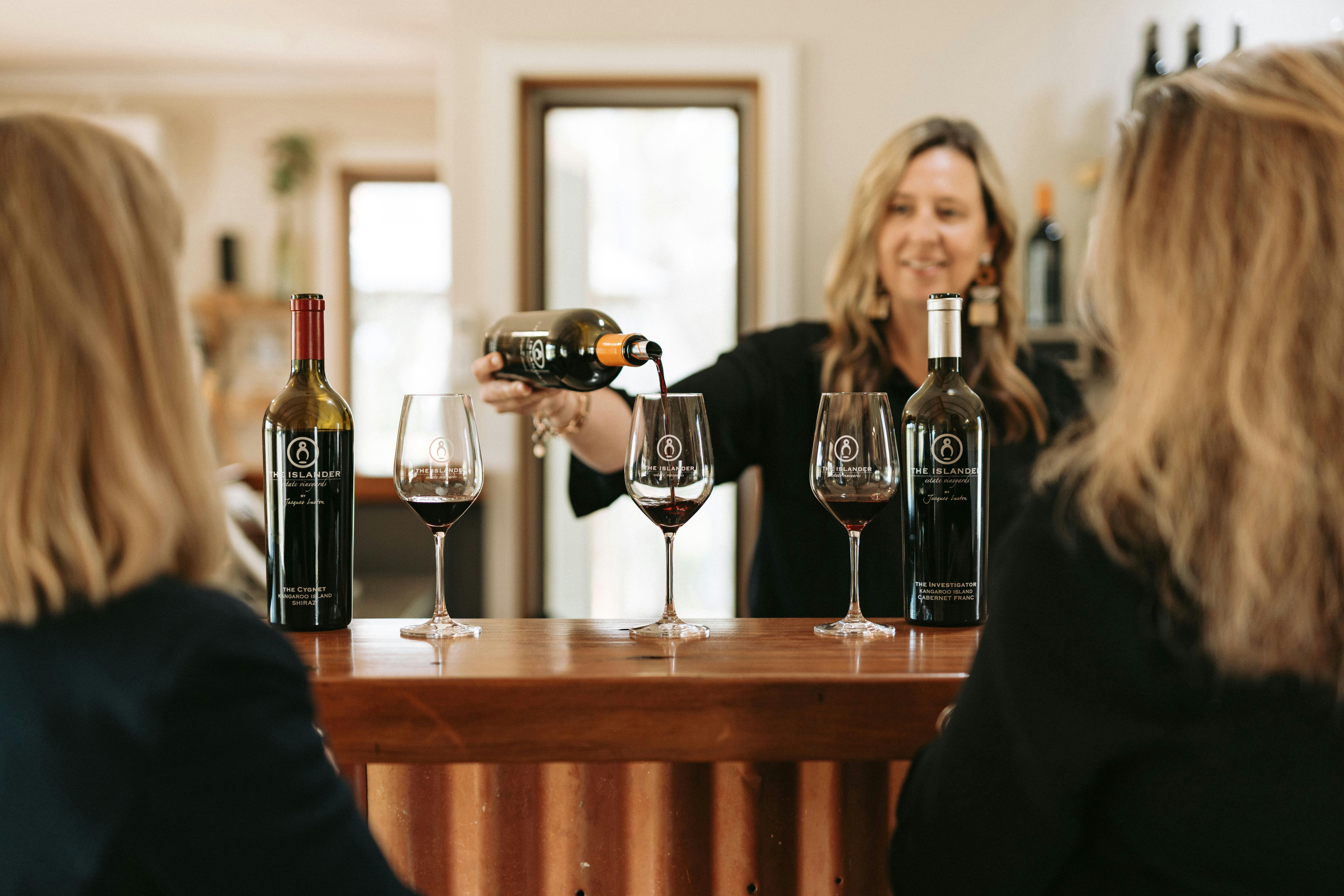 Two people having a tasting experience at The Islander Estate Vineyards